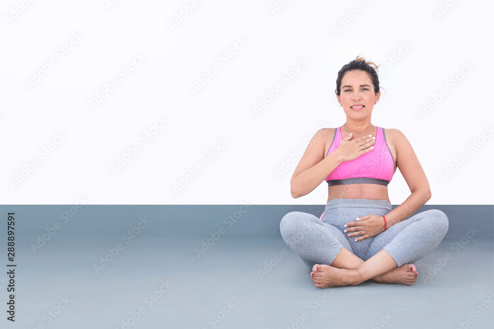 Woman sitting performing yoga, dressed in sportswear. Isolated on white background. Copyspace on the left side. Woman sitting performing yoga, dressed in sportswear. Isolated on white background. Copyspace on the left side.