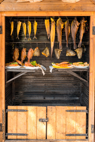 Various kinds of marine fish which hangs in a smokehouse for smoking. Concept: healthy diet or omega-3 fatty acids