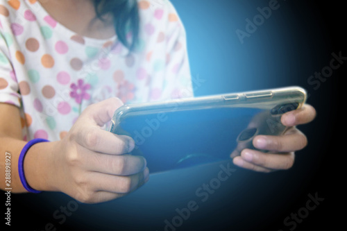 teen girl play smart phone, Blue light from mobile.