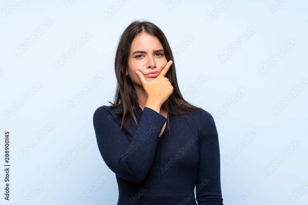 Young girl over isolated blue background thinking an idea Young girl over isolated blue background thinking an idea