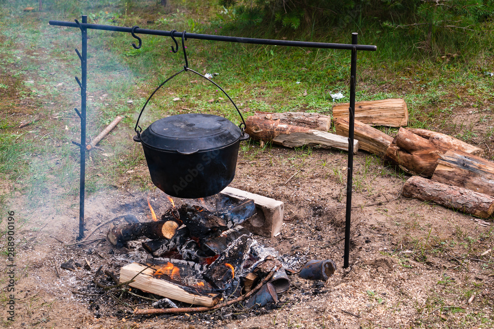 cooking at the stake in a cauldron, fire and smoke cooking at the stake in a cauldron, fire and smoke