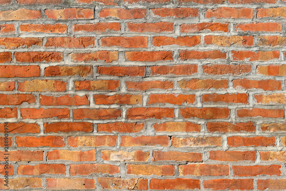 An old brick wall of red color. Background of red bricks. Brick wall texture. Perfect background with space An old brick wall of red color. Background of red bricks. Brick wall texture. Perfect background with space