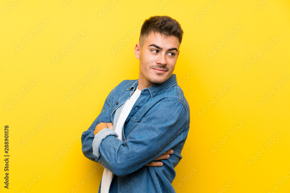 Young handsome man over isolated yellow background laughing Young handsome man over isolated yellow background laughing