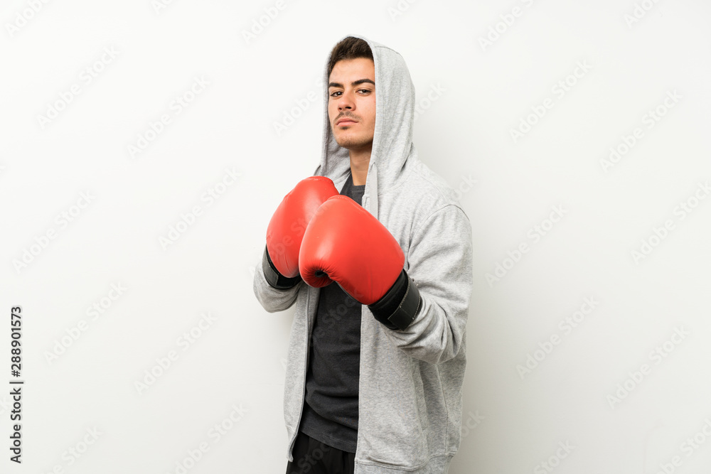 Sport man over isolated white wall with boxing gloves Sport man over isolated white wall with boxing gloves