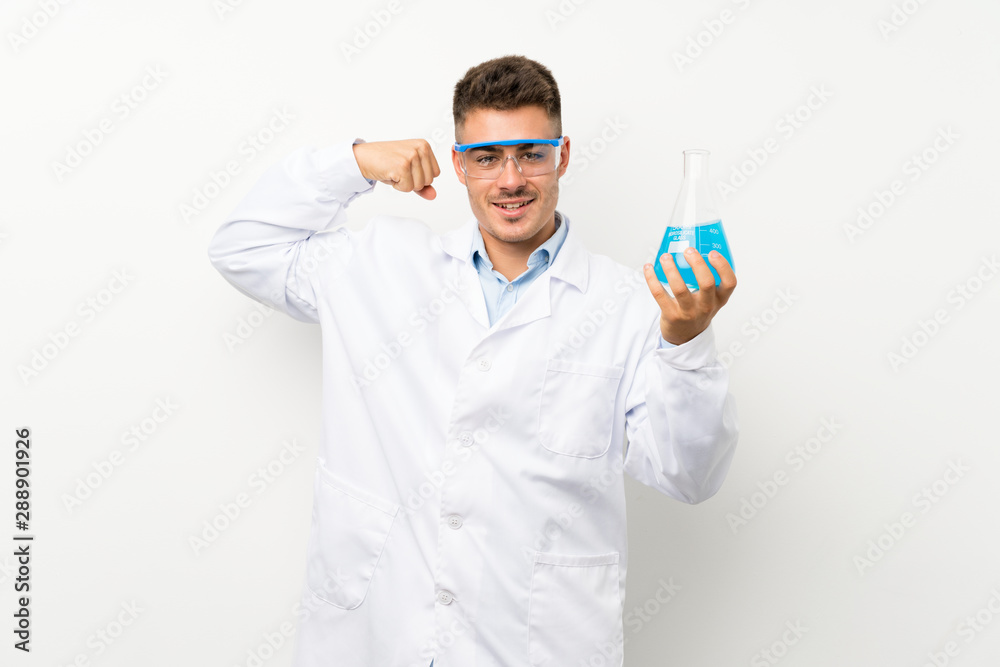 Young scientific holding laboratory flask over isolated background making strong gesture Young scientific holding laboratory flask over isolated background making strong gesture