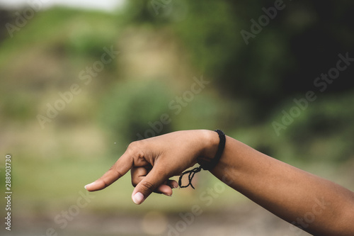 Close up of Human hand on a green background. © Yashvi