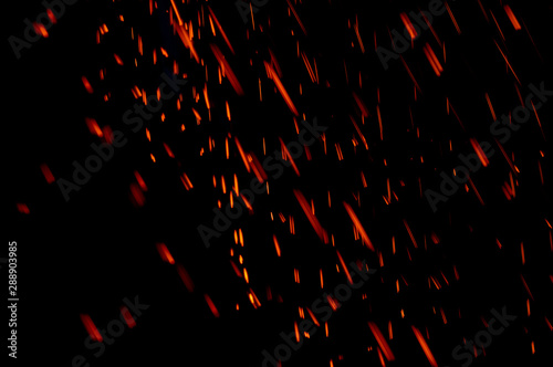 Abstract motion blur light background of particles. Red sparks.