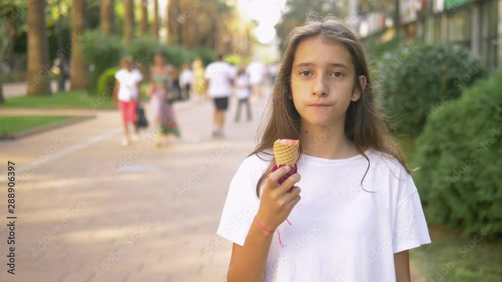 teen girl eating ice cream outdoors. The concept of childhood, lifestyle, food, summer. teen girl eating ice cream outdoors. The concept of childhood, lifestyle, food, summer.