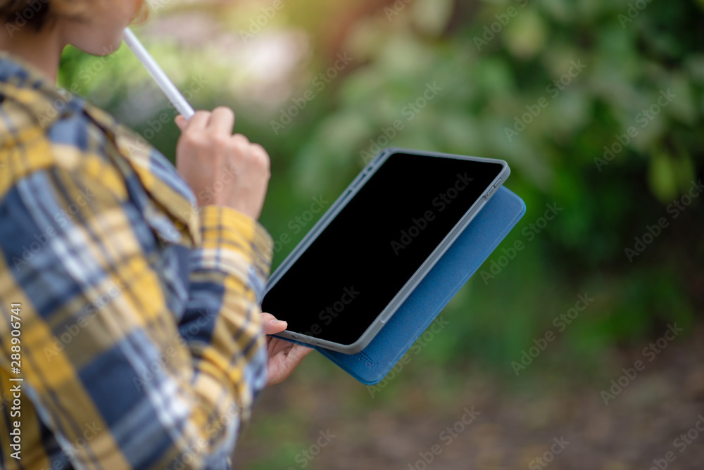 Close up of woman holding tablet and thinking. Lifestyle Concept