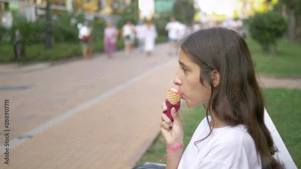 teen girl eating ice cream outdoors. The concept of childhood, lifestyle, food, summer. teen girl eating ice cream outdoors. The concept of childhood, lifestyle, food, summer.