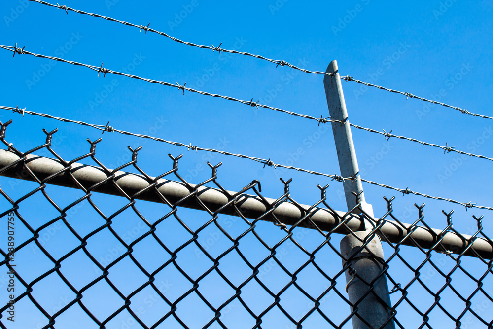 Barb wire fence blocking people climbing over Barb wire fence blocking people climbing over