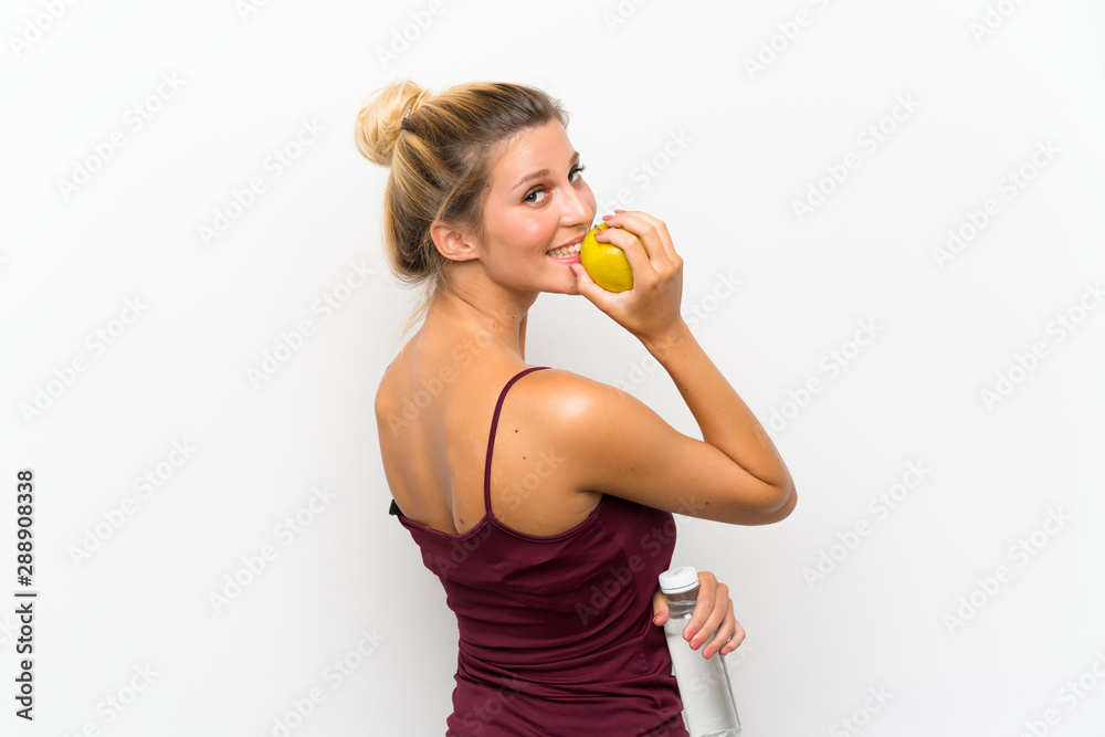 Young blonde girl with an apple and with a bottle of water Young blonde girl with an apple and with a bottle of water