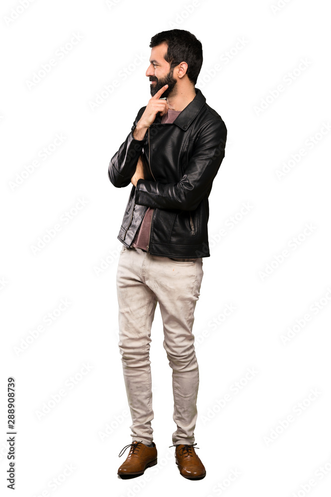 Handsome man with beard looking to the side over isolated white background Handsome man with beard looking to the side over isolated white background