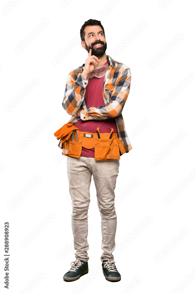Craftsmen man thinking an idea while looking up over isolated white background Craftsmen man thinking an idea while looking up over isolated white background