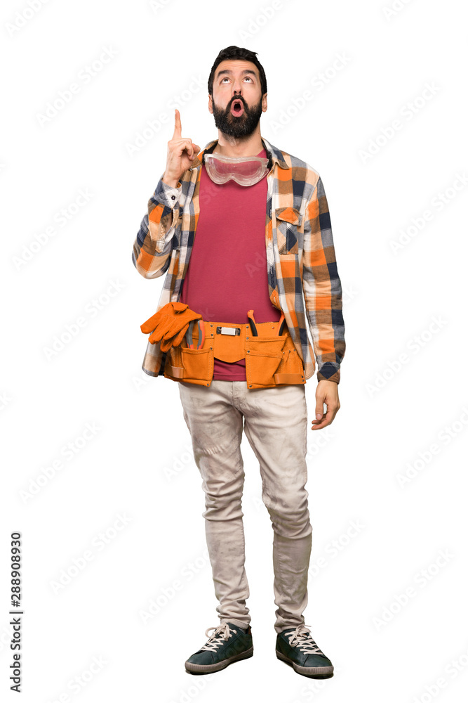 Craftsmen man pointing up and surprised over isolated white background Craftsmen man pointing up and surprised over isolated white background