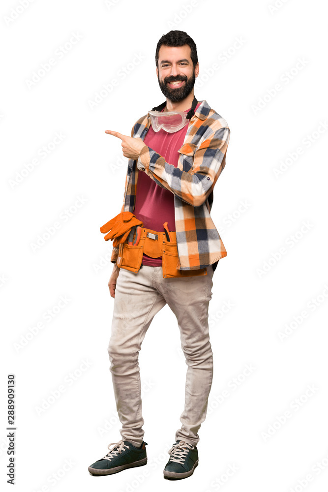 Craftsmen man pointing to the side to present a product over isolated white background Craftsmen man pointing to the side to present a product over isolated white background