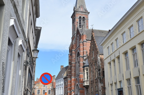 Bruges, Belgium. Image with Rozenhoedkaai in Brugge, Dijver river canal twilight and Belfort (Belfry) tower. photo