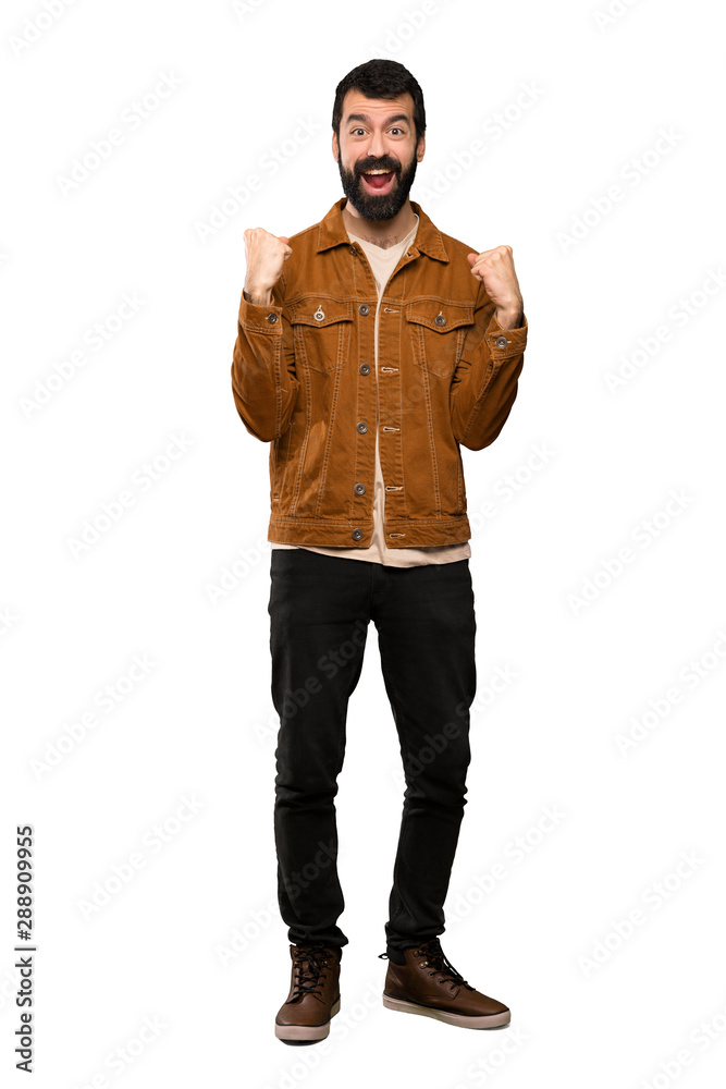 Handsome man with beard celebrating a victory in winner position over isolated white background Handsome man with beard celebrating a victory in winner position over isolated white background