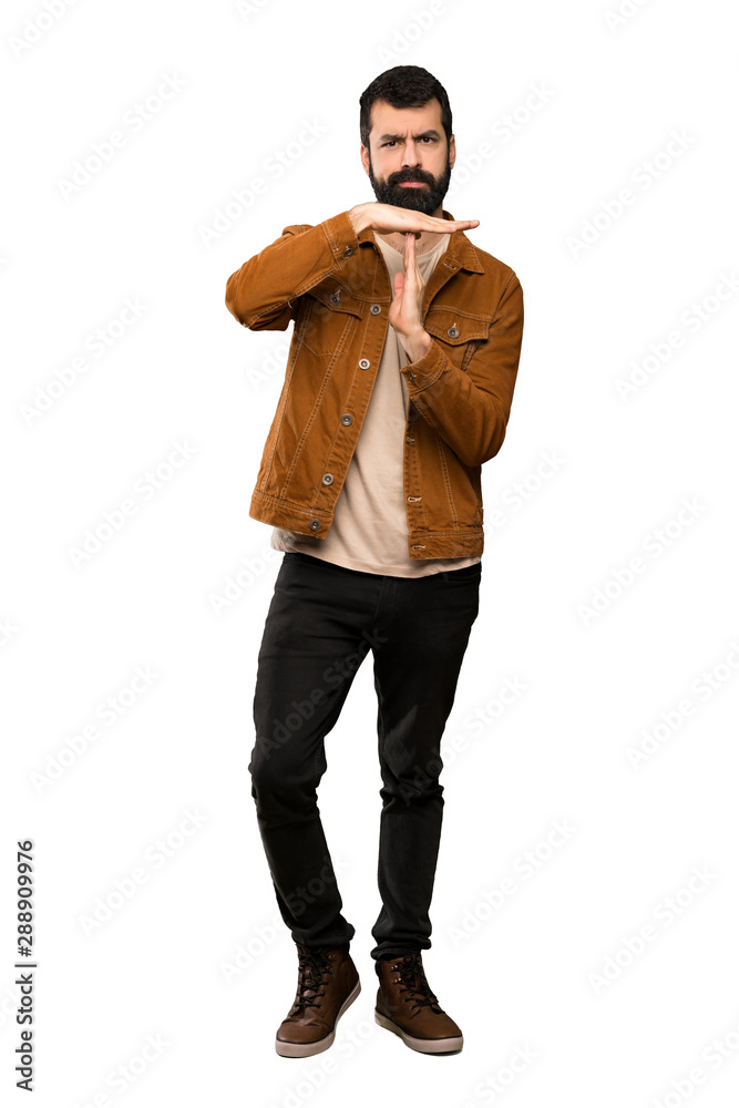 Handsome man with beard making time out gesture over isolated white background Handsome man with beard making time out gesture over isolated white background