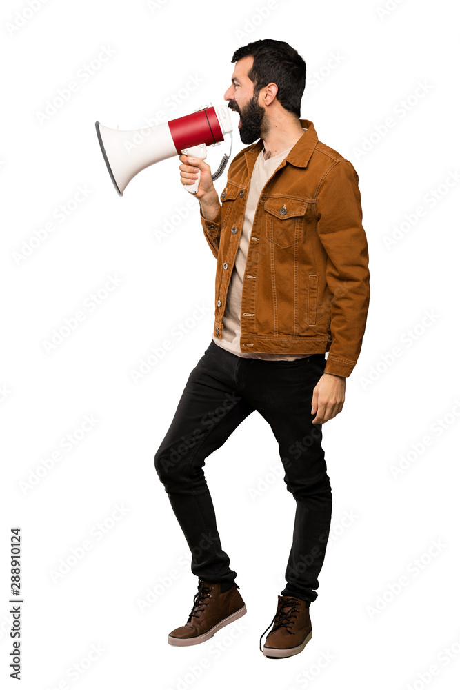 Handsome man with beard shouting through a megaphone over isolated white background Handsome man with beard shouting through a megaphone over isolated white background