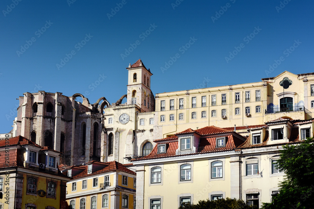 View over the buildings and on the apse of the Carmo Convent (Convento do Carmo) from the Rossio square in Lisbon, Portugal