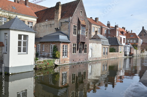 Bruges, Belgium. Image with Rozenhoedkaai in Brugge, Dijver river canal twilight and Belfort (Belfry) tower. photo