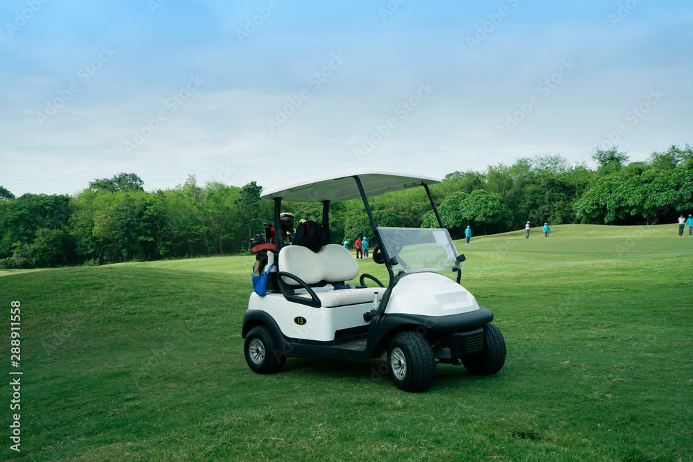 Golfcar in beautiful golf course in the evening golf course with sunshine