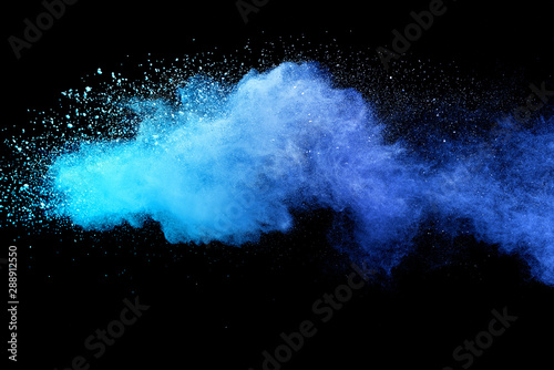 Blue sky color powder explosion on black background.