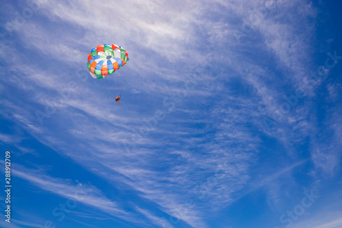 Fototapeta Naklejka Na Ścianę i Meble -  Colorful parasail wing against cloudy blue sky, Punta Cana, Dominican Republic