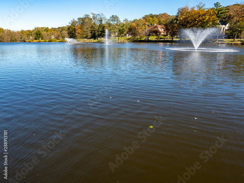 lake with water fountains in the fall