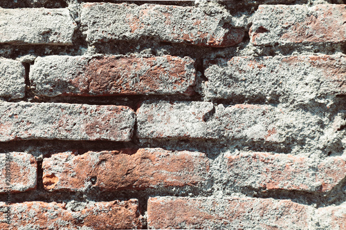 Brick wall for a background with old cracked stones, isolated, rough bricks for a texture loft style