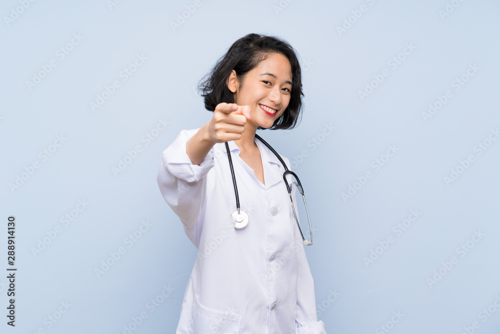 Doctor Asian woman points finger at you with a confident expression Doctor Asian woman points finger at you with a confident expression