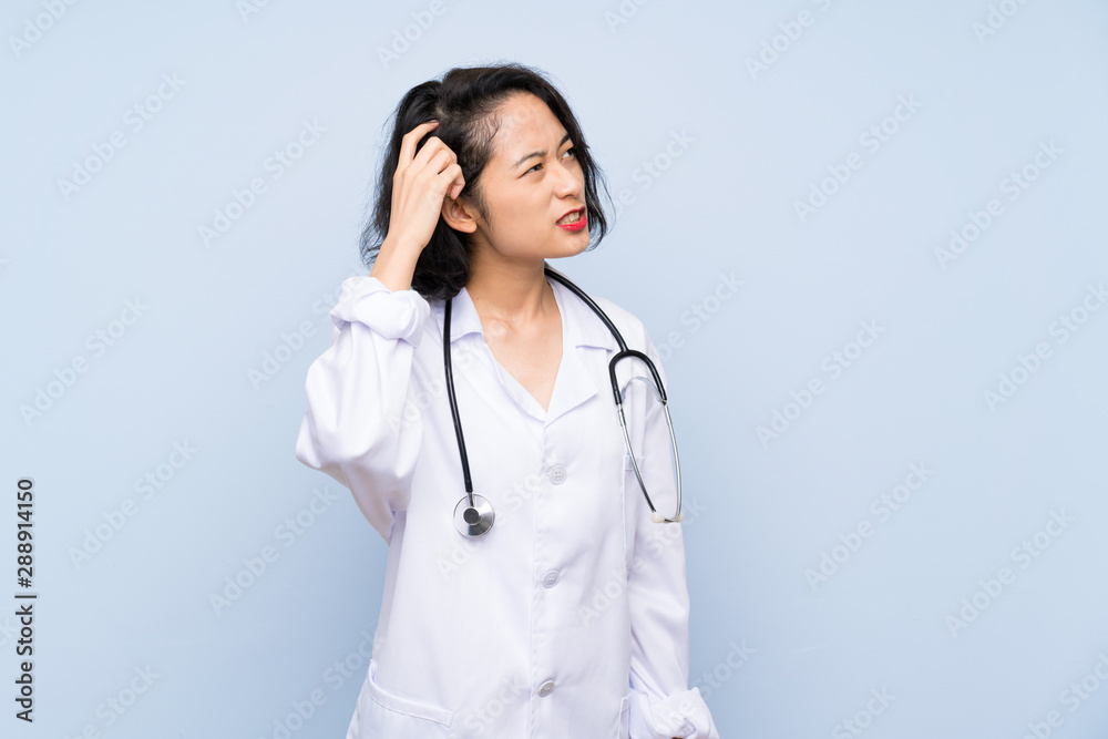 Doctor Asian woman having doubts and with confuse face expression Doctor Asian woman having doubts and with confuse face expression