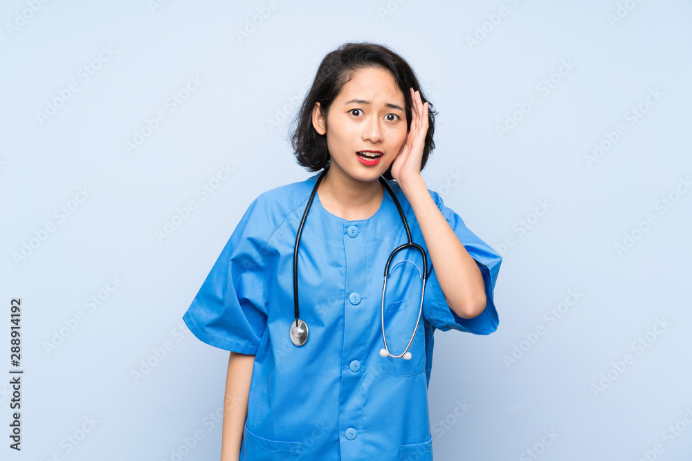 Surgeon doctor woman with surprise and shocked facial expression Surgeon doctor woman with surprise and shocked facial expression