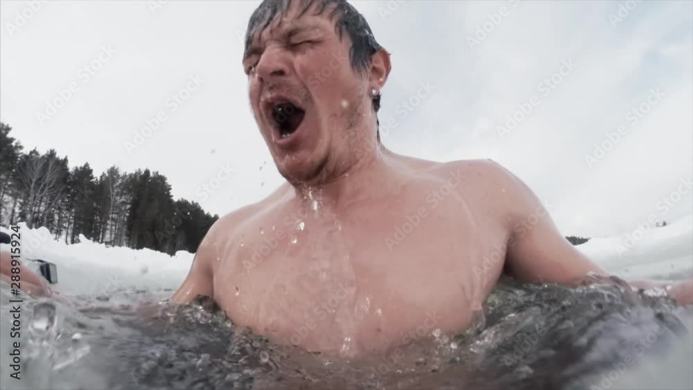 Seamless loopable clip of the young man swimming in the ice hole Seamless loopable clip of the young man swimming in the ice hole