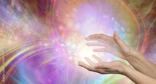 Obraz na plátne Sending you beautiful healing energy vibes - female cupped hands with white ener