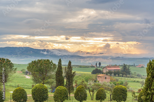 Sunset in Tuscany with rolling hills in a rural landscape view