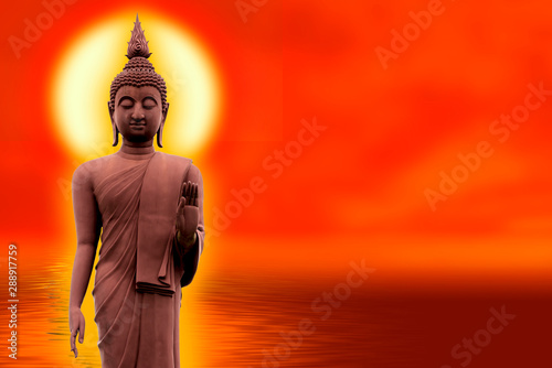The Buddha stands gracefully on a lotus flower with an orange background.(About Buddhism) photo