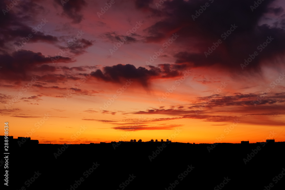 The silhouette of the city sunrise sky with clouds