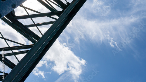 Abstract close up of the steel structure of the Tyne Bridge in Newcastle silhouetted against a beautiful summer sky. photo