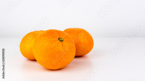 A group of vivid, easy peeler, juicy oranges isolated on a white studio background.