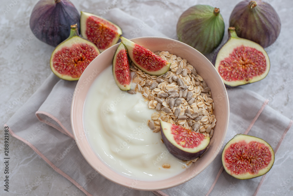 Oat granola with nuts, yogurt, honey, fresh figs and blueberries Oat granola with nuts, yogurt, honey, fresh figs and blueberries