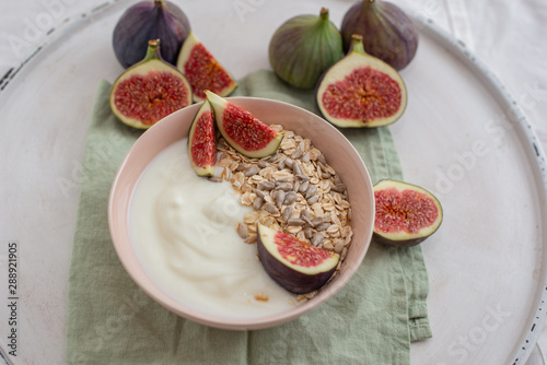 Oat granola with nuts, yogurt, honey, fresh figs and blueberries