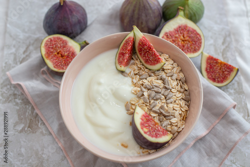 Oat granola with nuts, yogurt, honey, fresh figs and blueberries