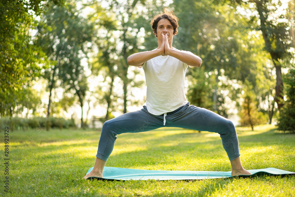 Young man meditating outdoors in the park Young man meditating outdoors in the park