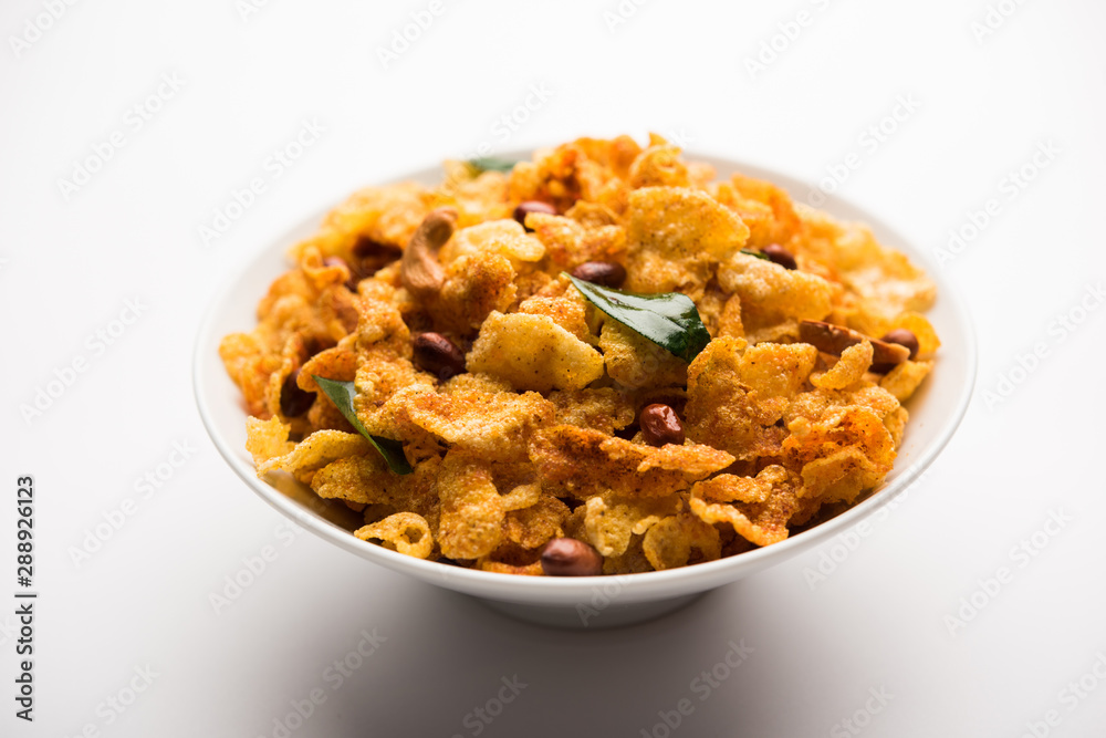 Cornflake Chivda or Corn Chiwda loaded with peanuts and Cashew. Served in a bowl. selective focus