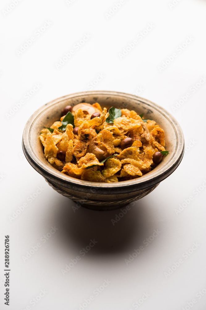 Cornflake Chivda or Corn Chiwda loaded with peanuts and Cashew. Served in a bowl. selective focus