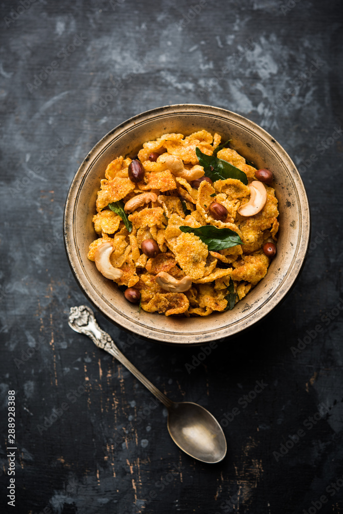 Fototapeta premium Cornflake Chivda or Corn Chiwda loaded with peanuts and Cashew. Served in a bowl. selective focus