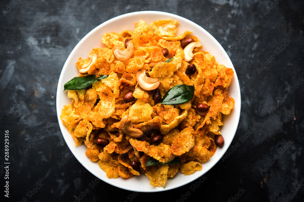 Cornflake Chivda or Corn Chiwda loaded with peanuts and Cashew. Served in a bowl. selective focus Cornflake Chivda or Corn Chiwda loaded with peanuts and Cashew. Served in a bowl. selective focus