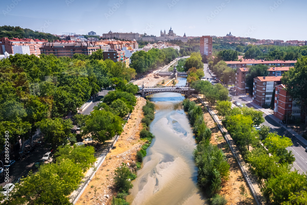 Fototapeta premium Madrid, Spain - August 25, 2019: Aerial view of the Manzanares River as it passes through Madrid.